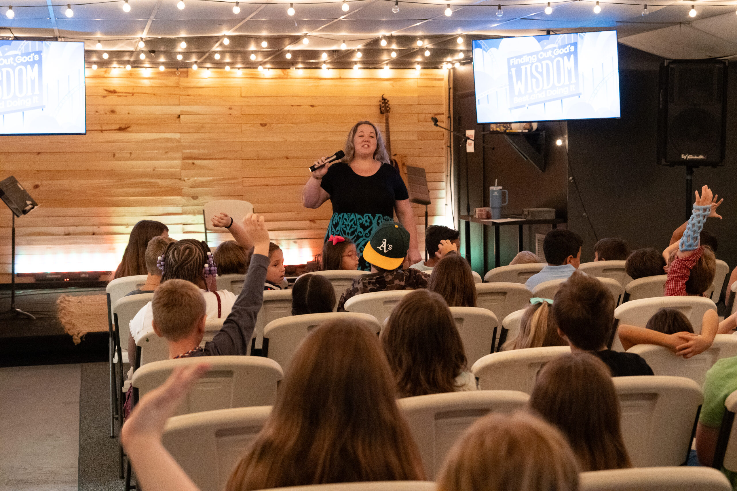 Leader teaching and interacting with children during Bethany Kids