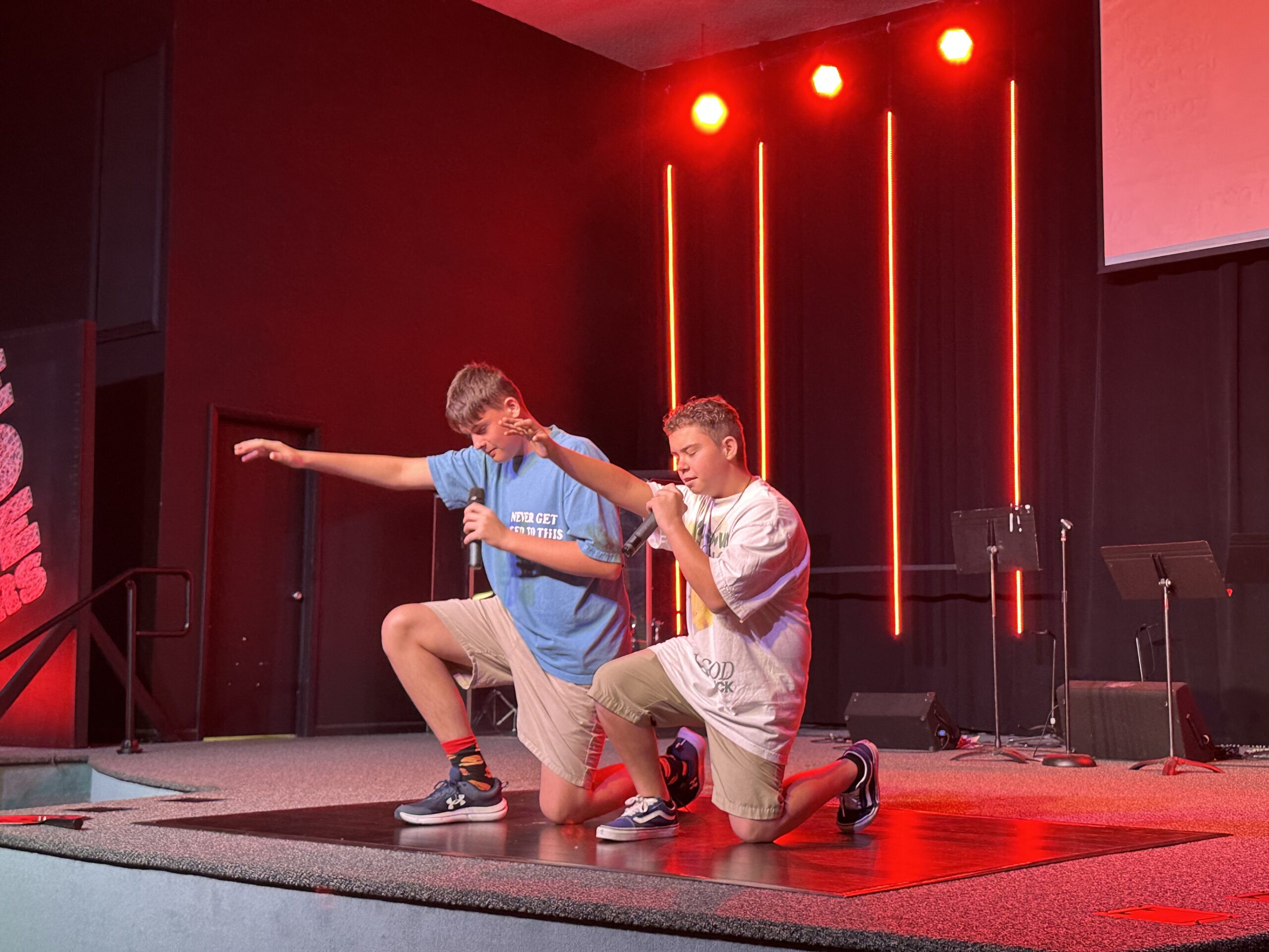 Bethany Youth students leading worship on stage during a church service
