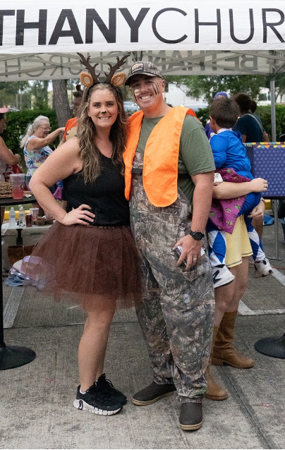 Families and volunteers gathered at a church trunk or treat outreach event