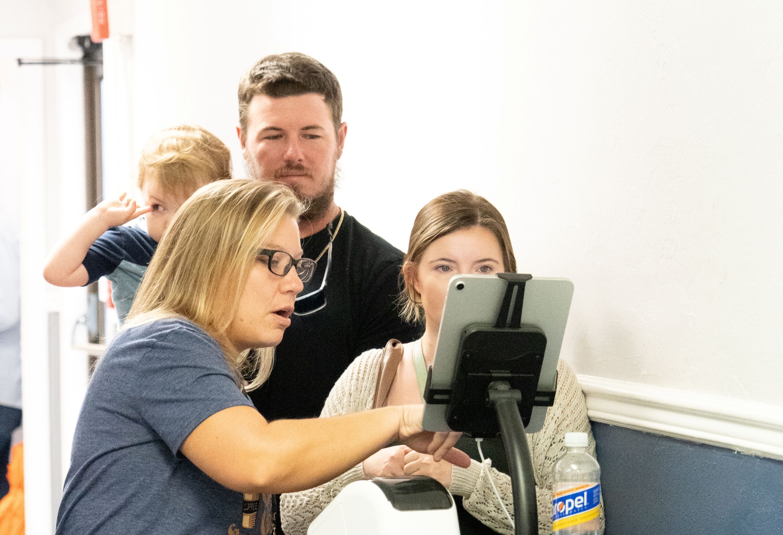 Parents checking in children at the Little Ones ministry registration station
