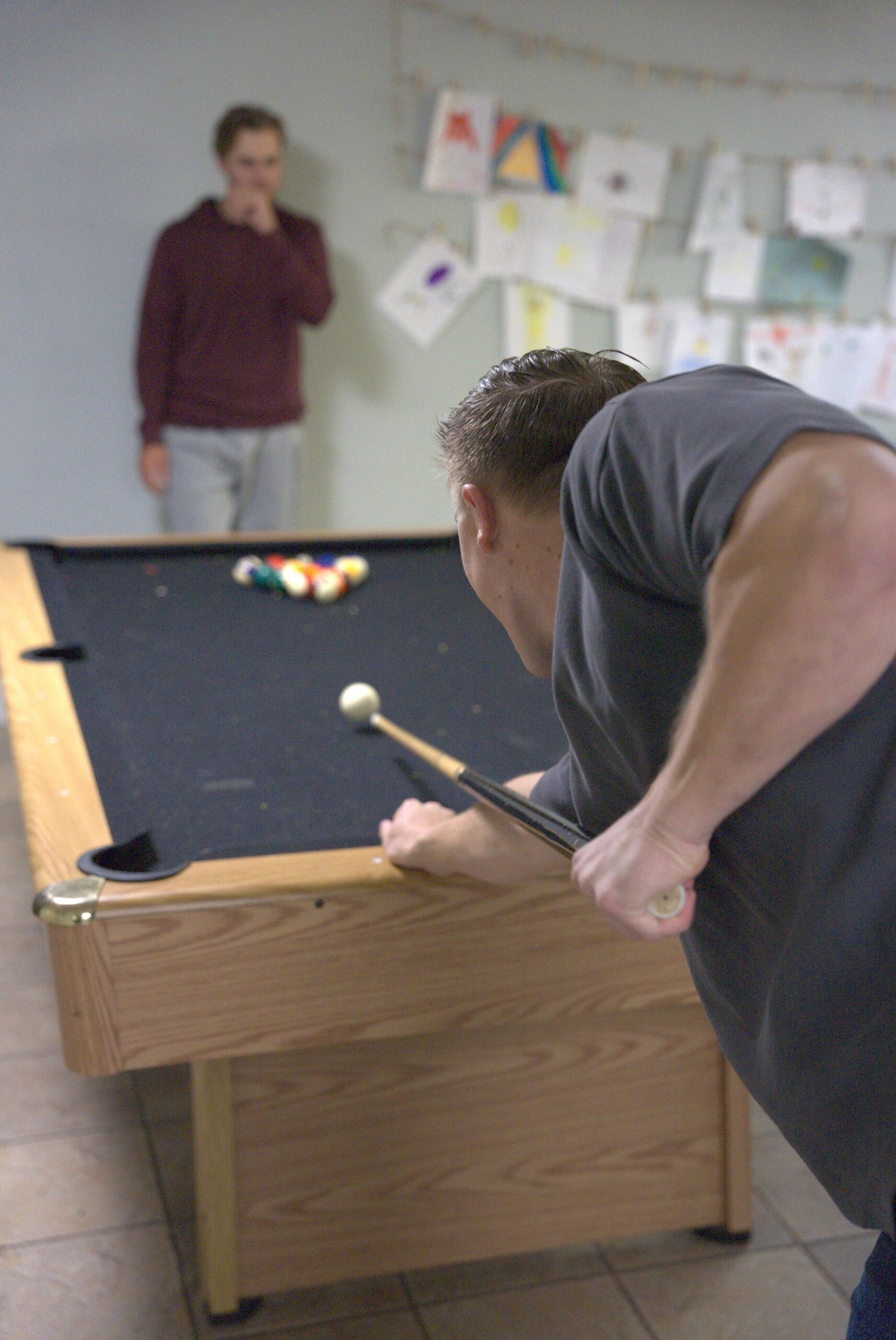 Young adults playing pool together during a fellowship time at The Pursuit