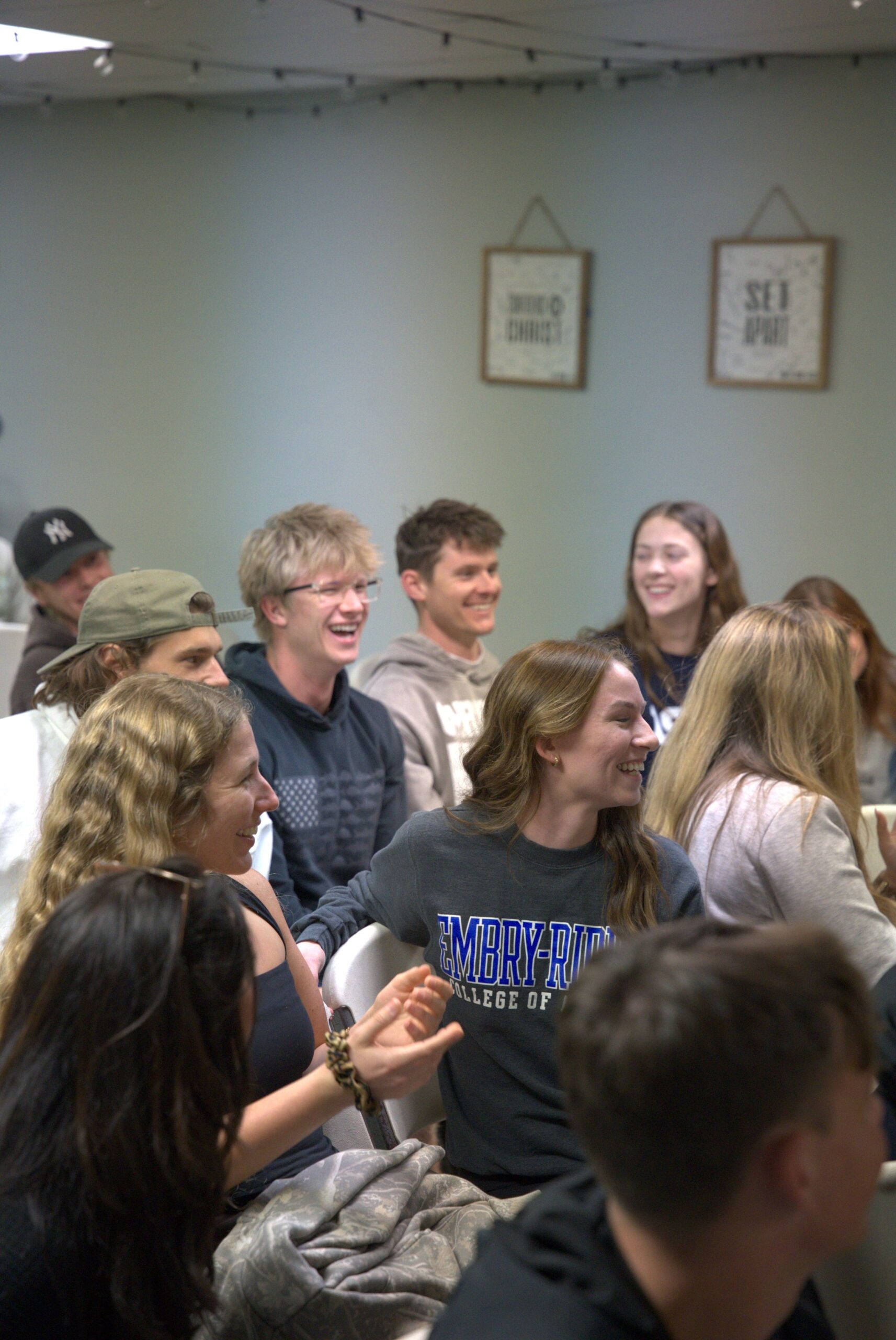 Young adults bowed in prayer and studying Scripture together during The Pursuit