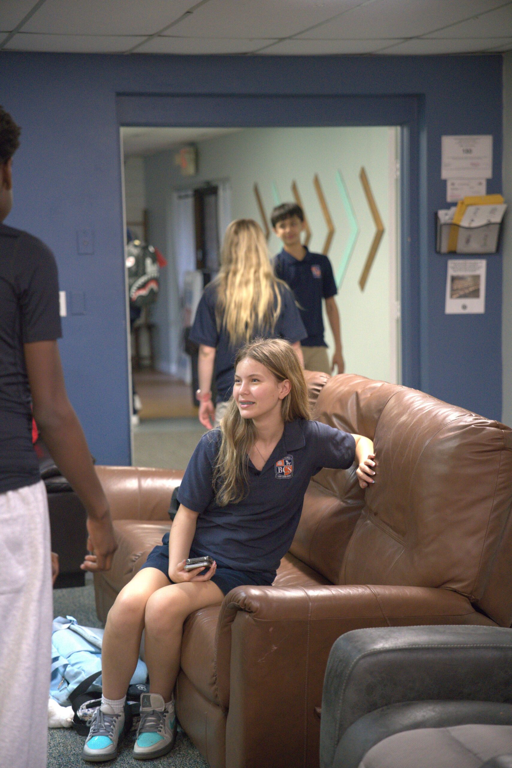 Students talking and building friendships in the Bethany Youth lounge area before youth service