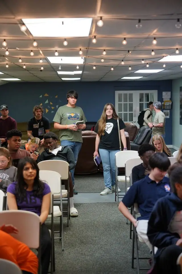 Student leading worship with guitar during a Bethany Youth gathering