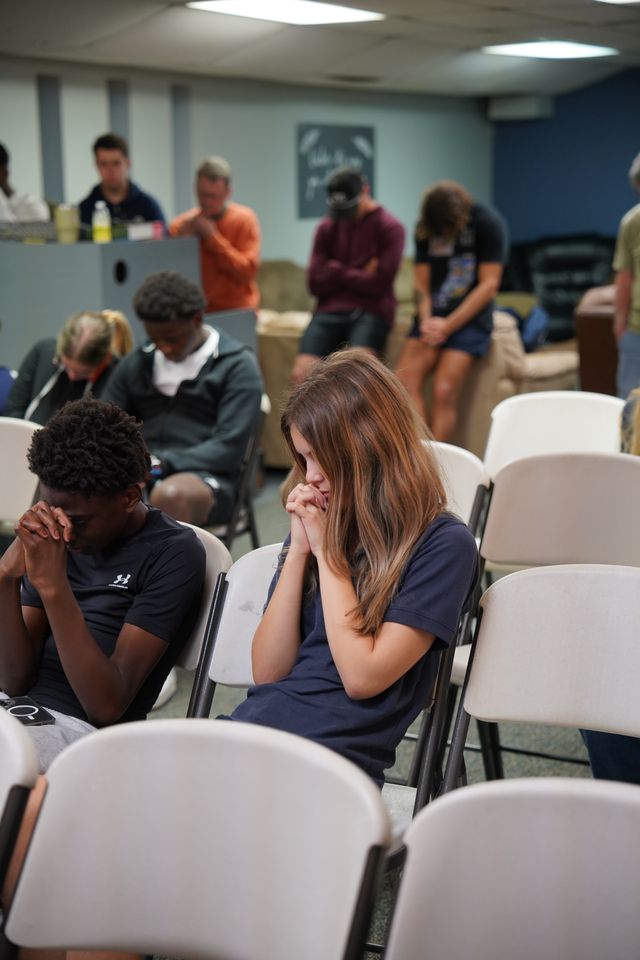 Bethany Youth students praying during a Wednesday night gathering