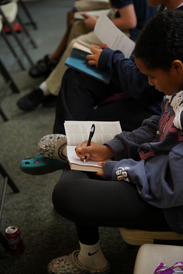 Bethany Youth students reading the Bible and taking notes during service