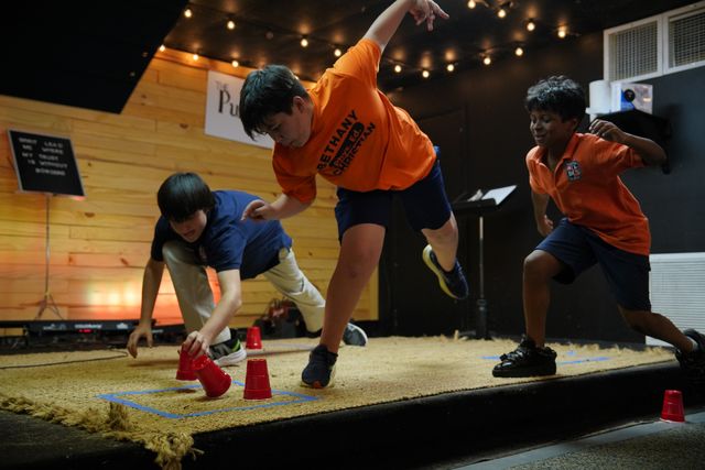 Student taking notes in a Bible during Bethany Youth teaching time