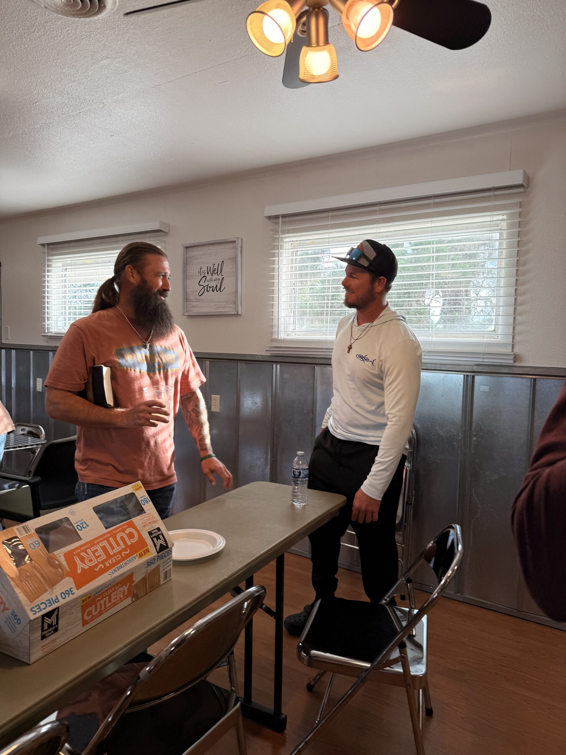 Two men connecting in conversation after a Bethany Men gathering at Bethany Church in West Melbourne, Florida