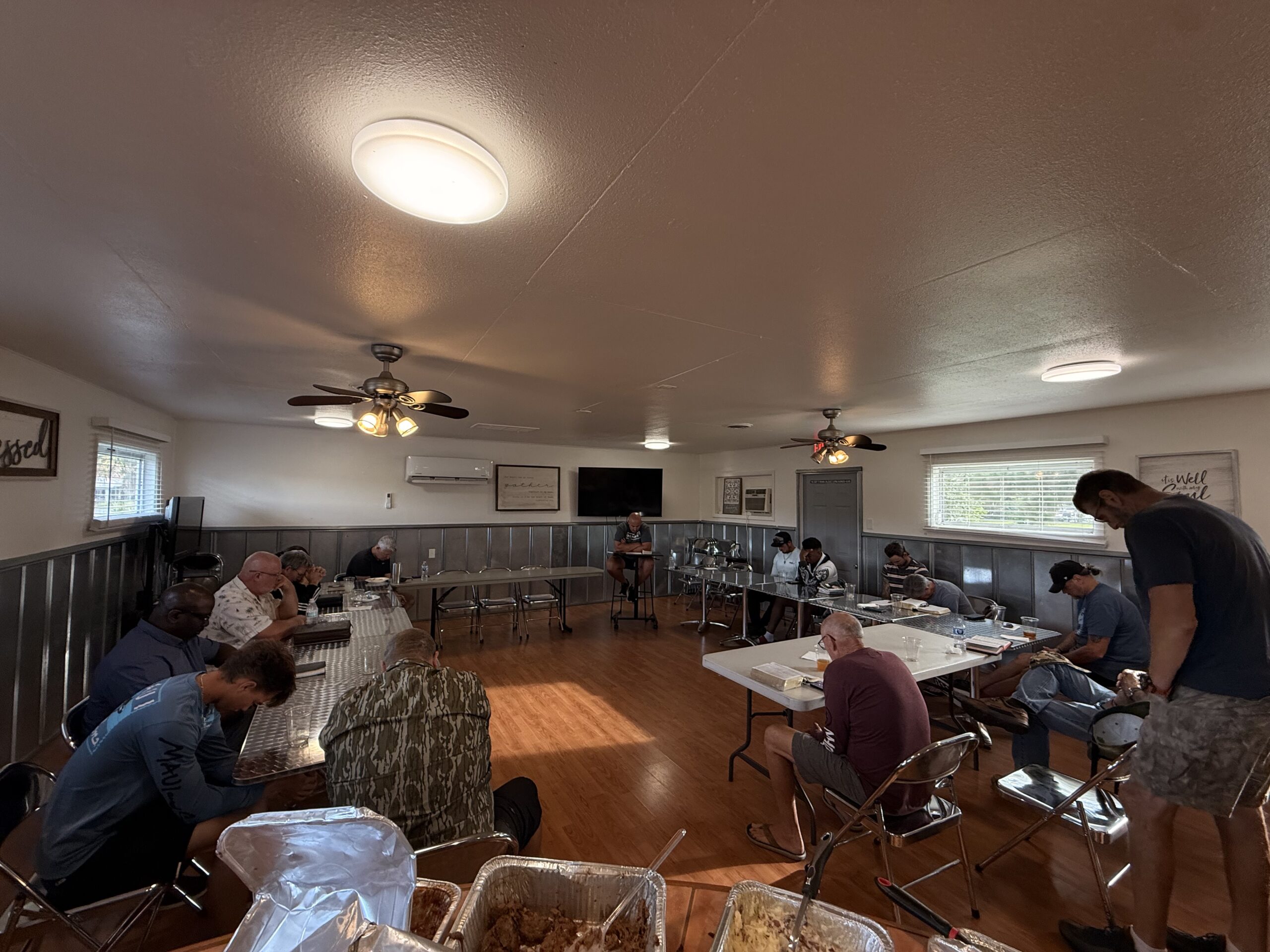 Men praying together during a Bethany Men gathering at Bethany Church in West Melbourne, Florida